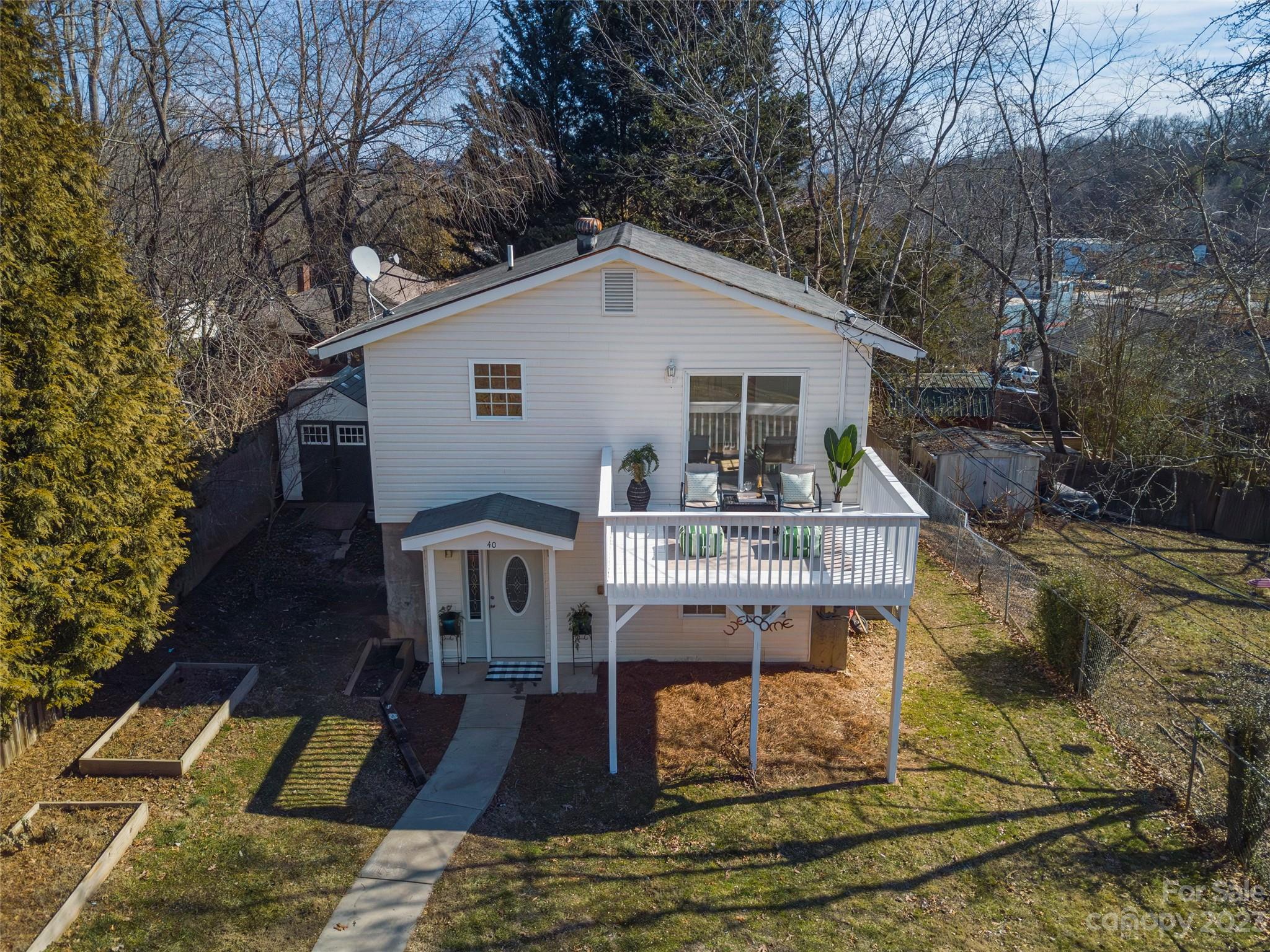 a view of house with a yard and patio