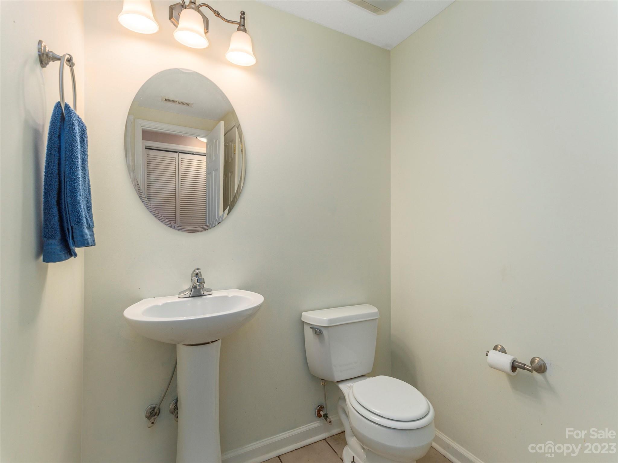 40 Laurel Loop Asheville, NC 28806 - Photo 12 of 26 a bathroom with a toilet sink and mirror