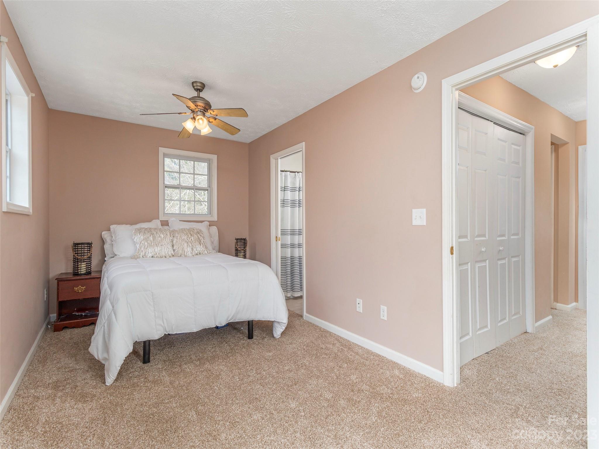 40 Laurel Loop Asheville, NC 28806 - Photo 13 of 26 a spacious bedroom with a bed and a chandelier