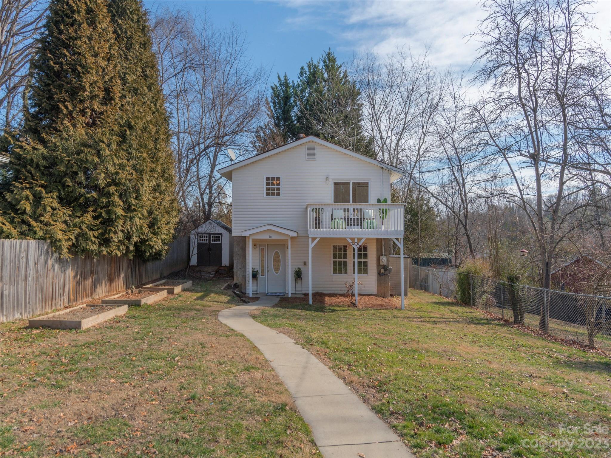 40 Laurel Loop Asheville, NC 28806 - Photo 25 of 26 a front view of a house with a yard tree and wooden fence