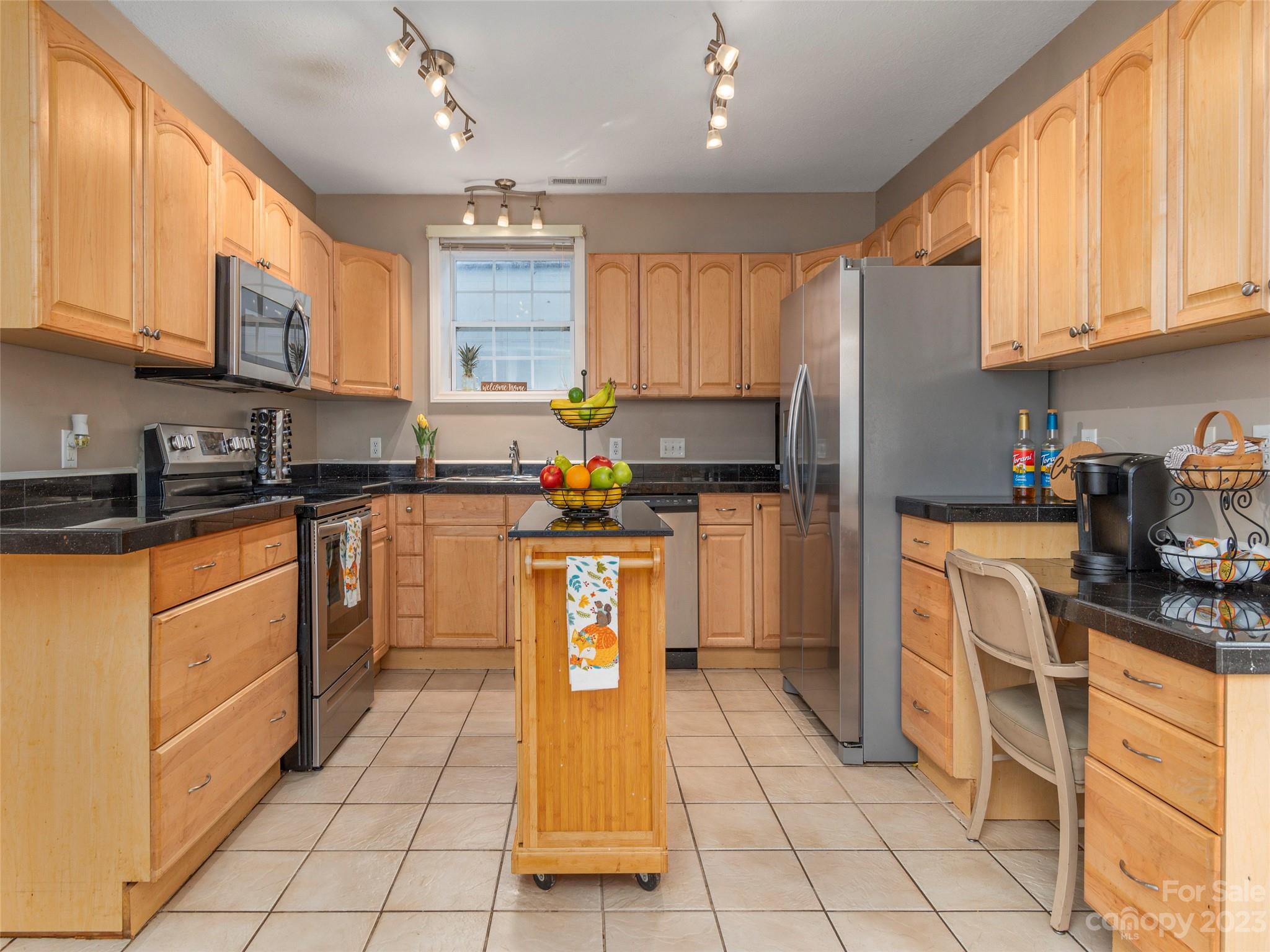 40 Laurel Loop Asheville, NC 28806 - Photo 6 of 26 a kitchen with stainless steel appliances granite countertop a stove a sink dishwasher and a refrigerator