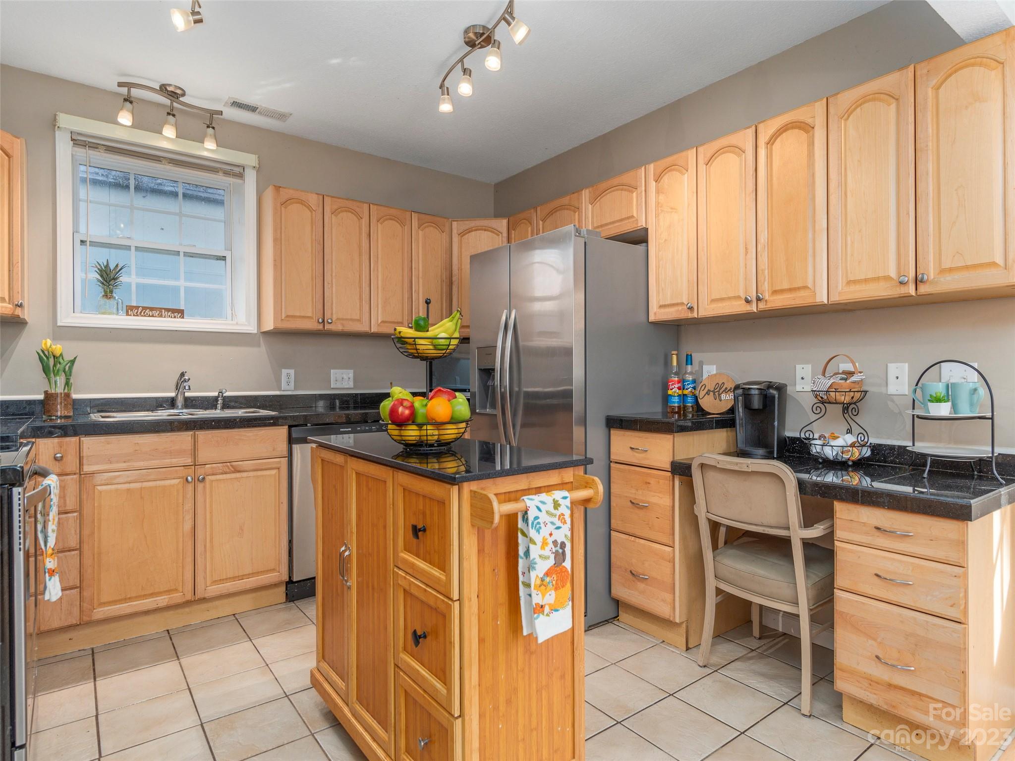 40 Laurel Loop Asheville, NC 28806 - Photo 7 of 26 a kitchen with stainless steel appliances granite countertop a refrigerator sink and cabinets