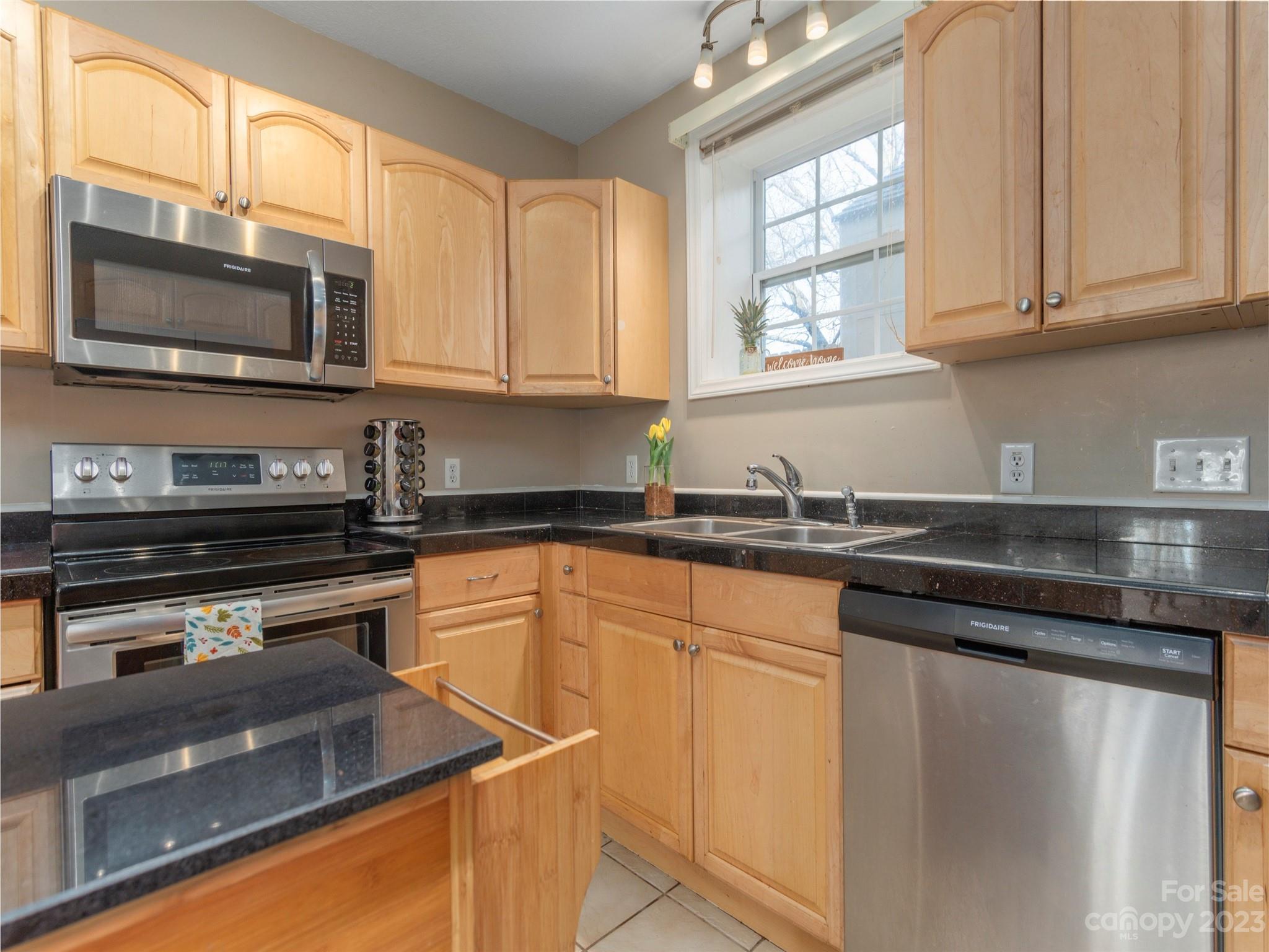 40 Laurel Loop Asheville, NC 28806 - Photo 8 of 26 a kitchen with stainless steel appliances granite countertop a sink stove and microwave