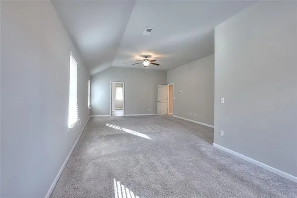 a view of a livingroom with a ceiling fan and window