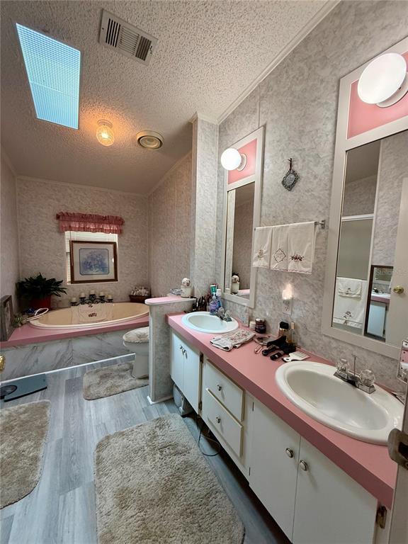 340 Debra Street Inglis, FL 34449 - Photo 22 of 29 a bathroom with a tub sink and mirror