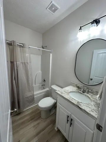 a bed room with a bed and a television