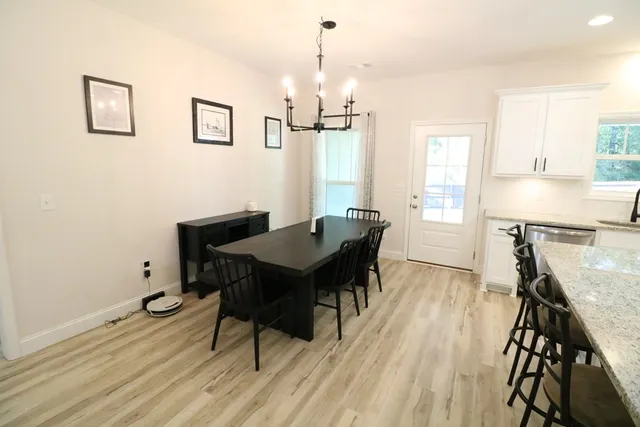 a view of a dining room with furniture window and wooden floor