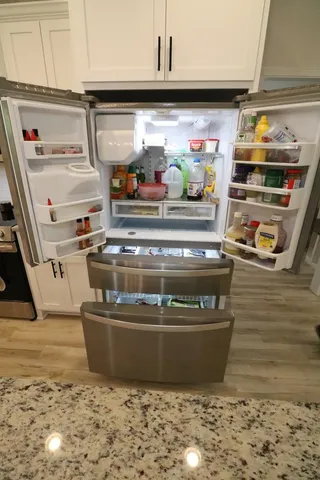 a stove top oven sitting inside of a kitchen