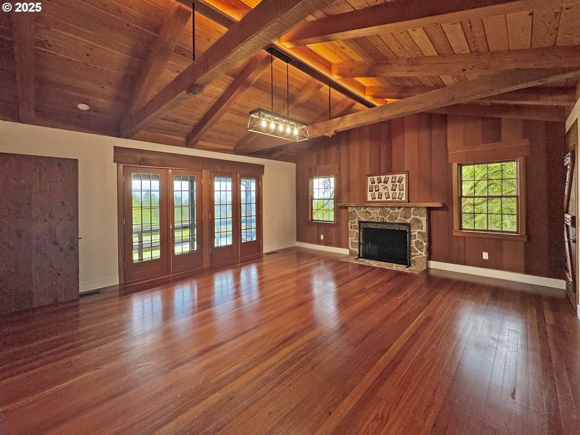 11890 Dupee Valley Road, Unit 1 Sheridan, OR 97378 - Photo 13 of 48 a view of an empty room with wooden floor fireplace and a window