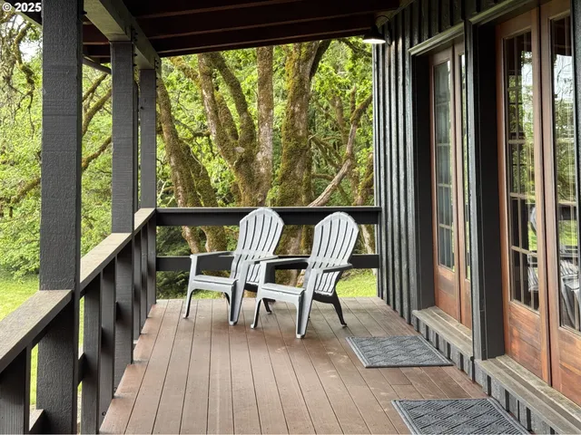 a view of a balcony with chairs and wooden floor
