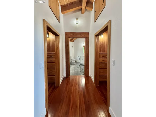 a spacious bathroom with a double vanity sink a mirror and a shower