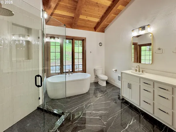 a bathroom with a double vanity sink a toilet and a mirror