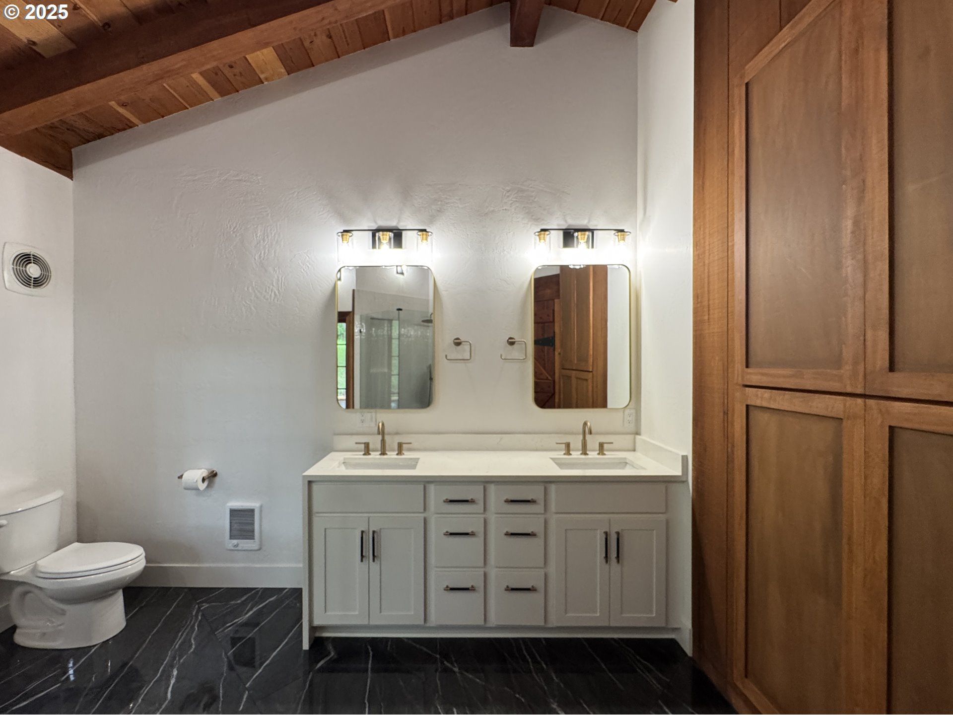 11890 Dupee Valley Road, Unit 1 Sheridan, OR 97378 - Photo 19 of 48 a bathroom with a double vanity sink a toilet and a mirror