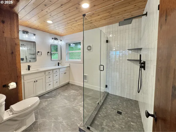 a view of a kitchen with cabinets and wooden floor