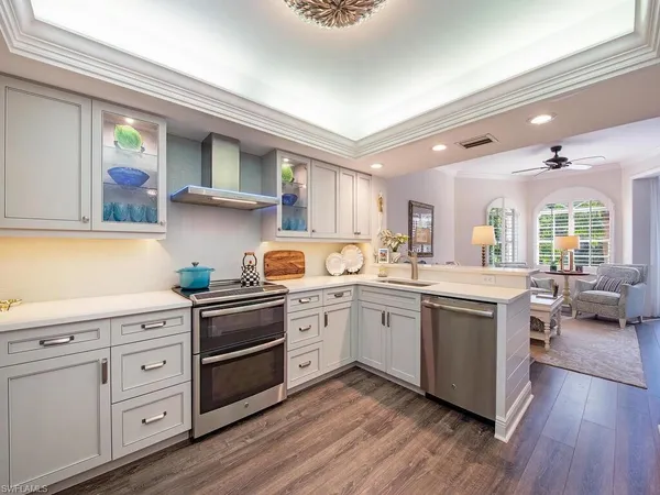 a kitchen with sink a stove and cabinets