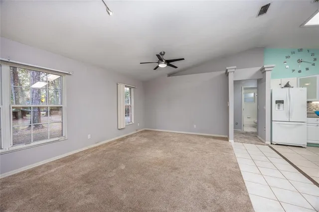 a view of a livingroom with a ceiling fan and window
