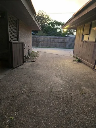 a view of backyard and wooden fence