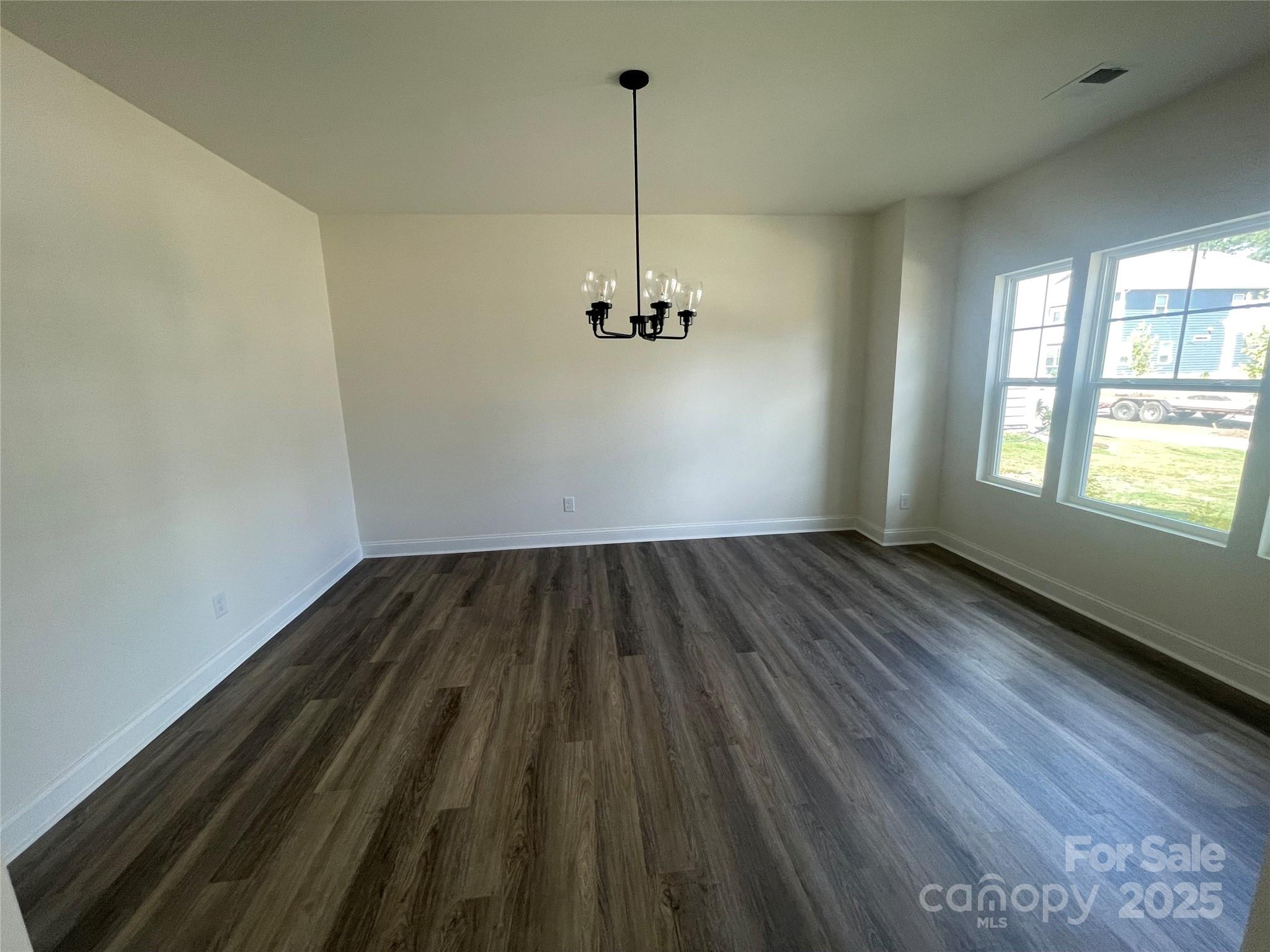 4044 Grommet Court Matthews, NC 28105 - Photo 11 of 27 a view of a room with wooden floor ceiling fan and window
