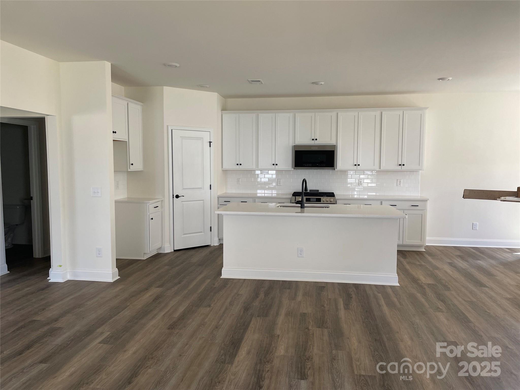 4044 Grommet Court Matthews, NC 28105 - Photo 16 of 27 a view wooden kitchen with granite countertop white cabinets and stainless steel appliances