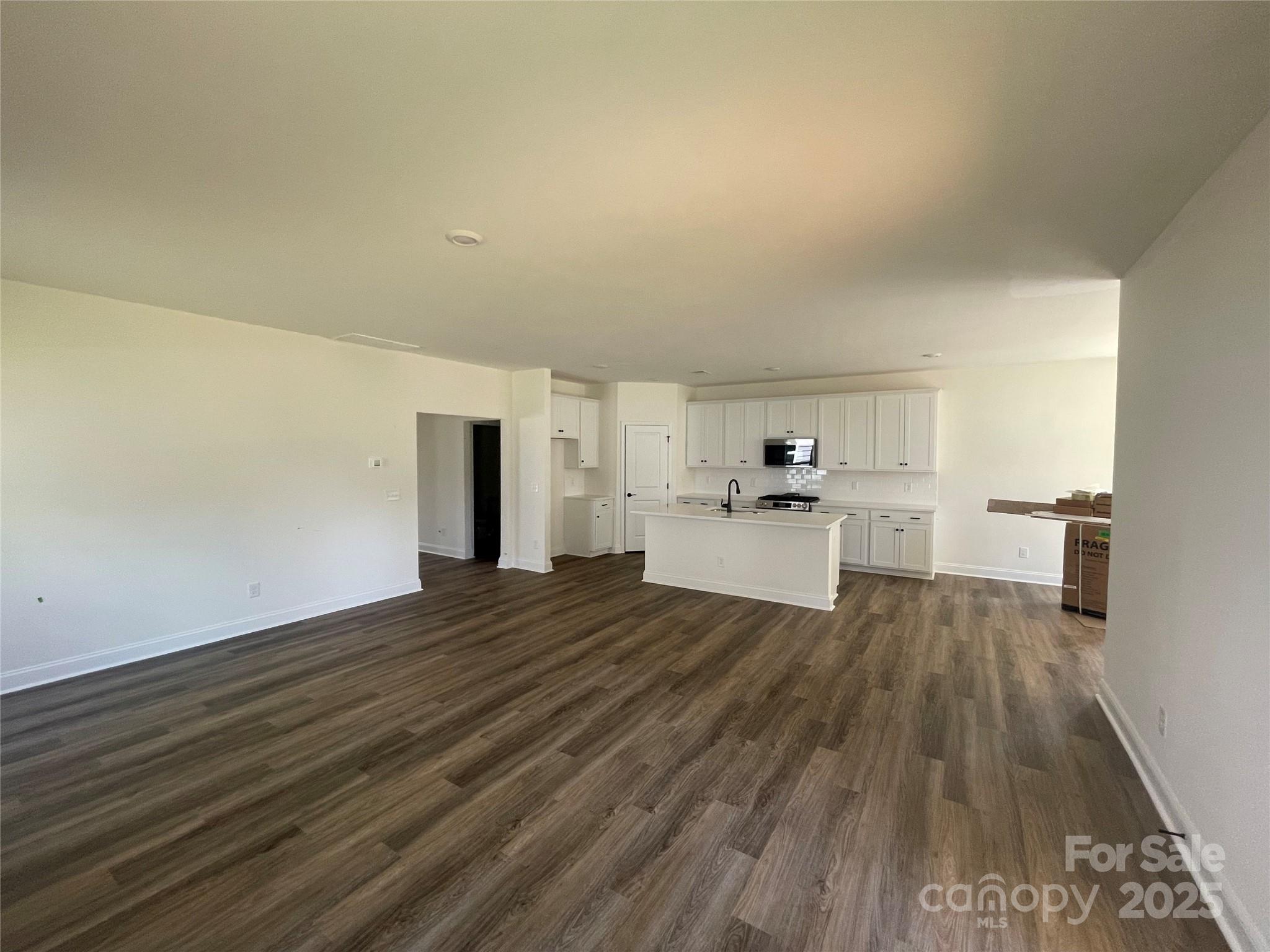 4044 Grommet Court Matthews, NC 28105 - Photo 19 of 27 a view of a kitchen with wooden floor and a sink