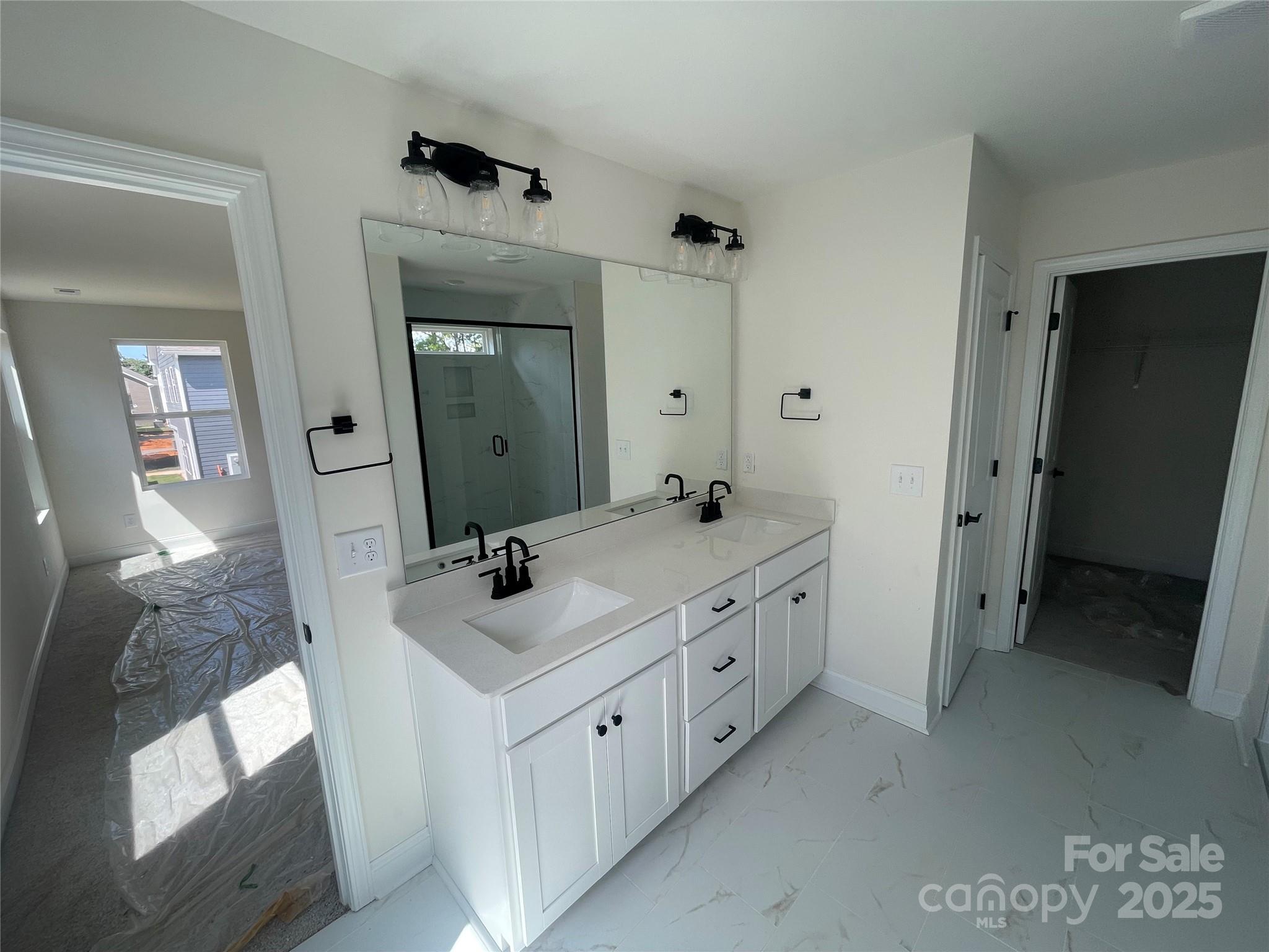 4044 Grommet Court Matthews, NC 28105 - Photo 21 of 27 a bathroom with double sink and mirror