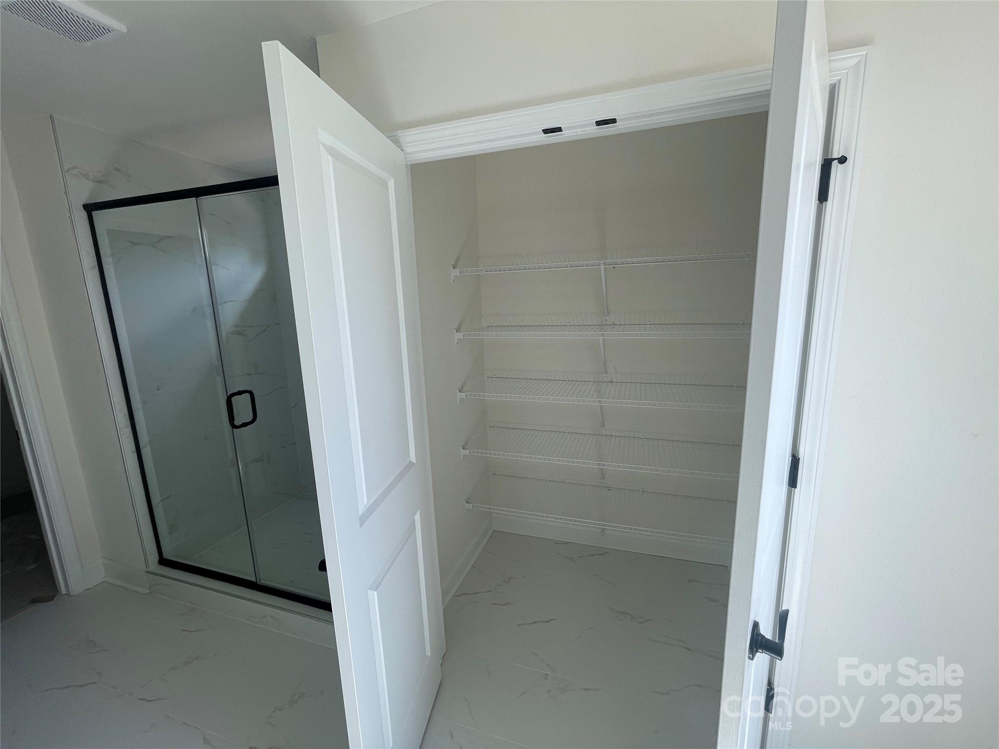 4044 Grommet Court Matthews, NC 28105 - Photo 23 of 27 a bathroom with a glass door shower