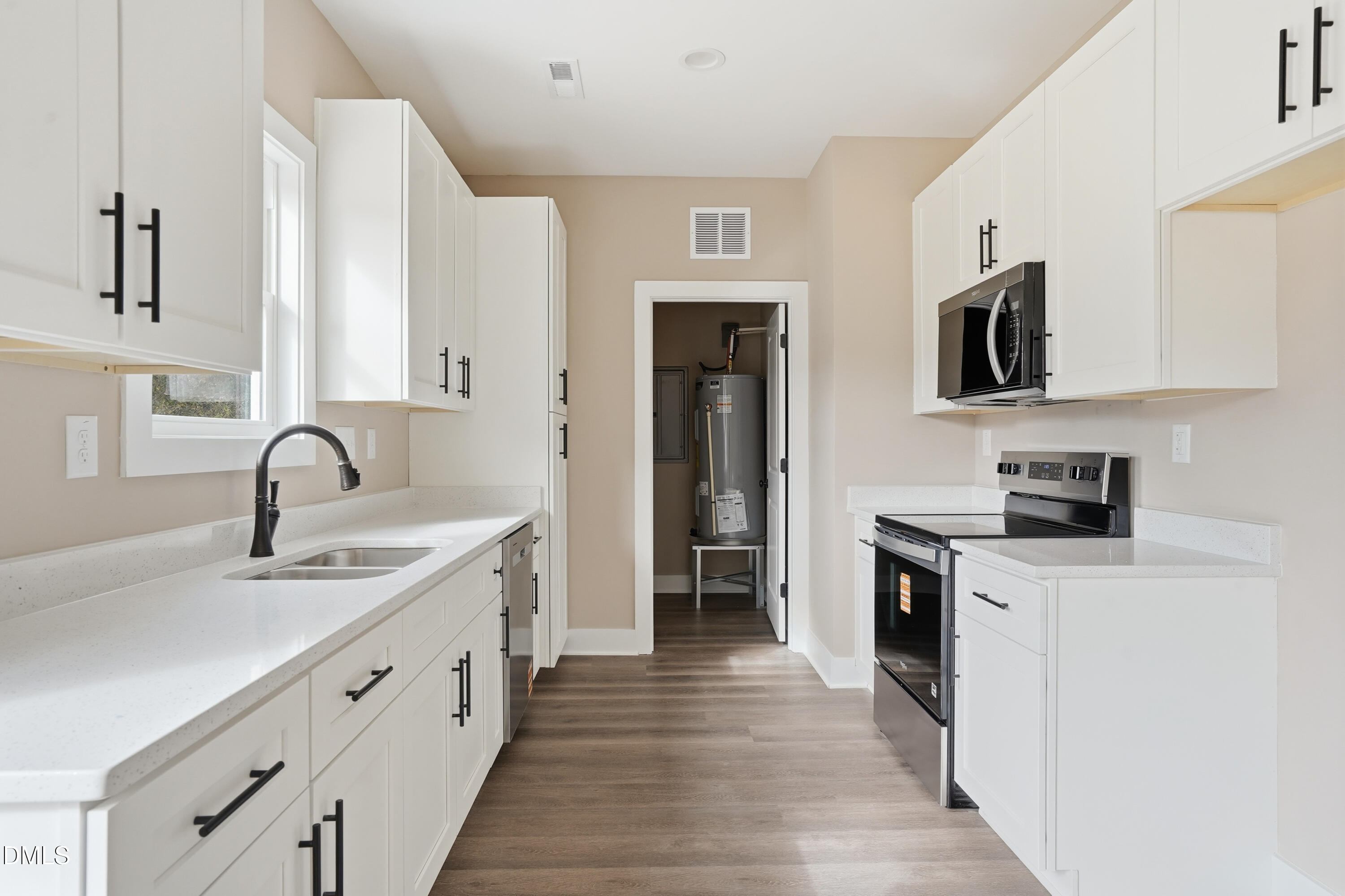 1115 Jada Allen Road Dunn, NC 28334 - Photo 10 of 32 a kitchen with white cabinets stainless steel appliances and sink