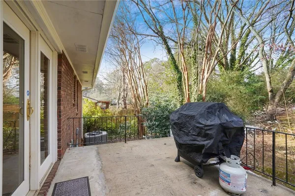 a view of backyard with outdoor seating and trees