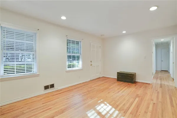 a big room with wooden floor and windows