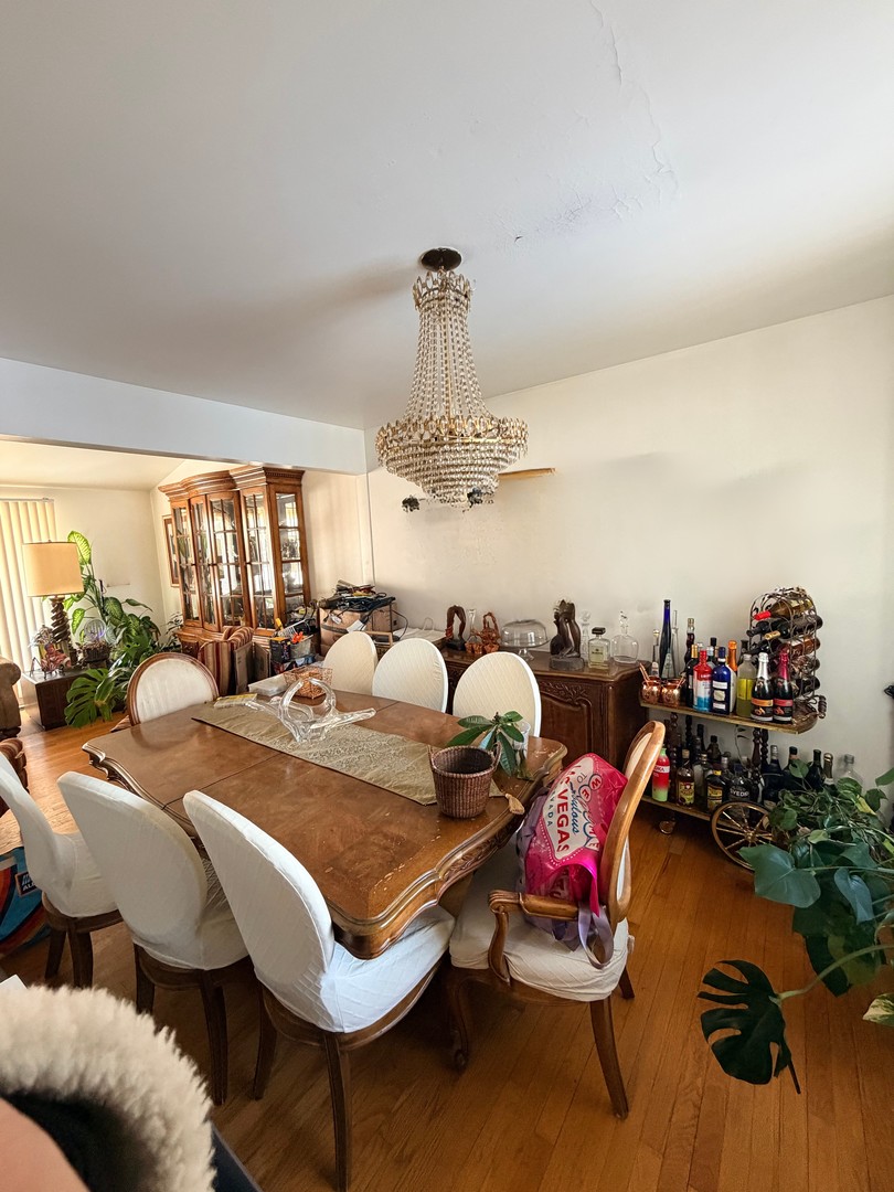 9013 Oriole Avenue Morton Grove, IL 60053 - Photo 8 of 17 a living room with furniture and a chandelier