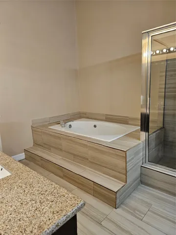 a bathroom with a bathtub and shower