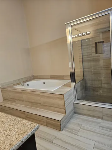 a bathroom with a bathtub and shower