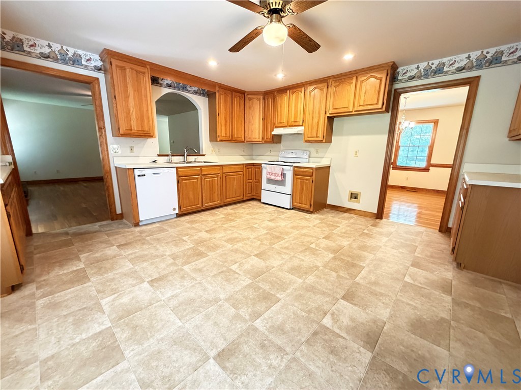 3933 Dunraven Road North Chesterfield, VA 23236 - Photo 18 of 30 a large kitchen with granite countertop a sink a counter top space cabinets and stainless steel appliances