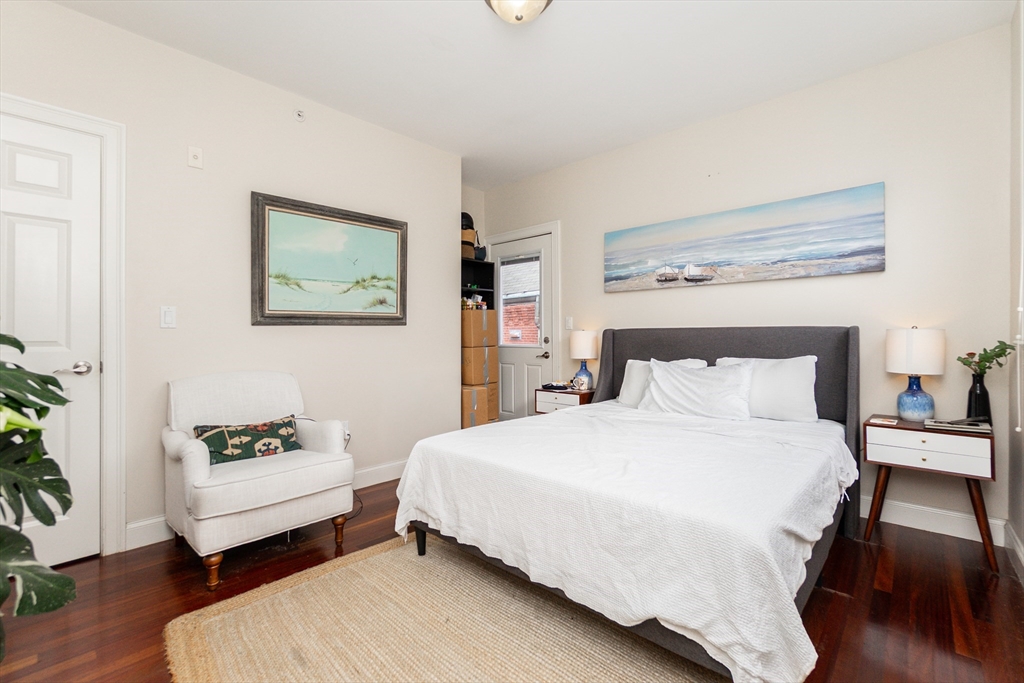 55 Kelly Road, Unit 3 Cambridge, MA 02139 - Photo 3 of 10 a bedroom with a bed and a couch