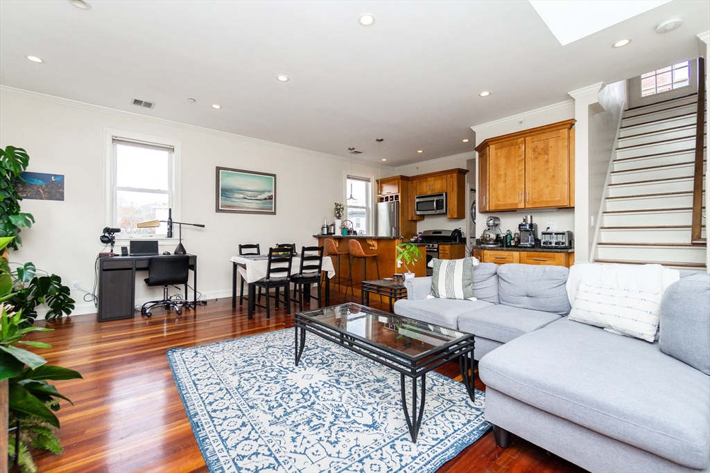 55 Kelly Road, Unit 3 Cambridge, MA 02139 - Photo 5 of 10 a living room with furniture flat screen tv and a large window
