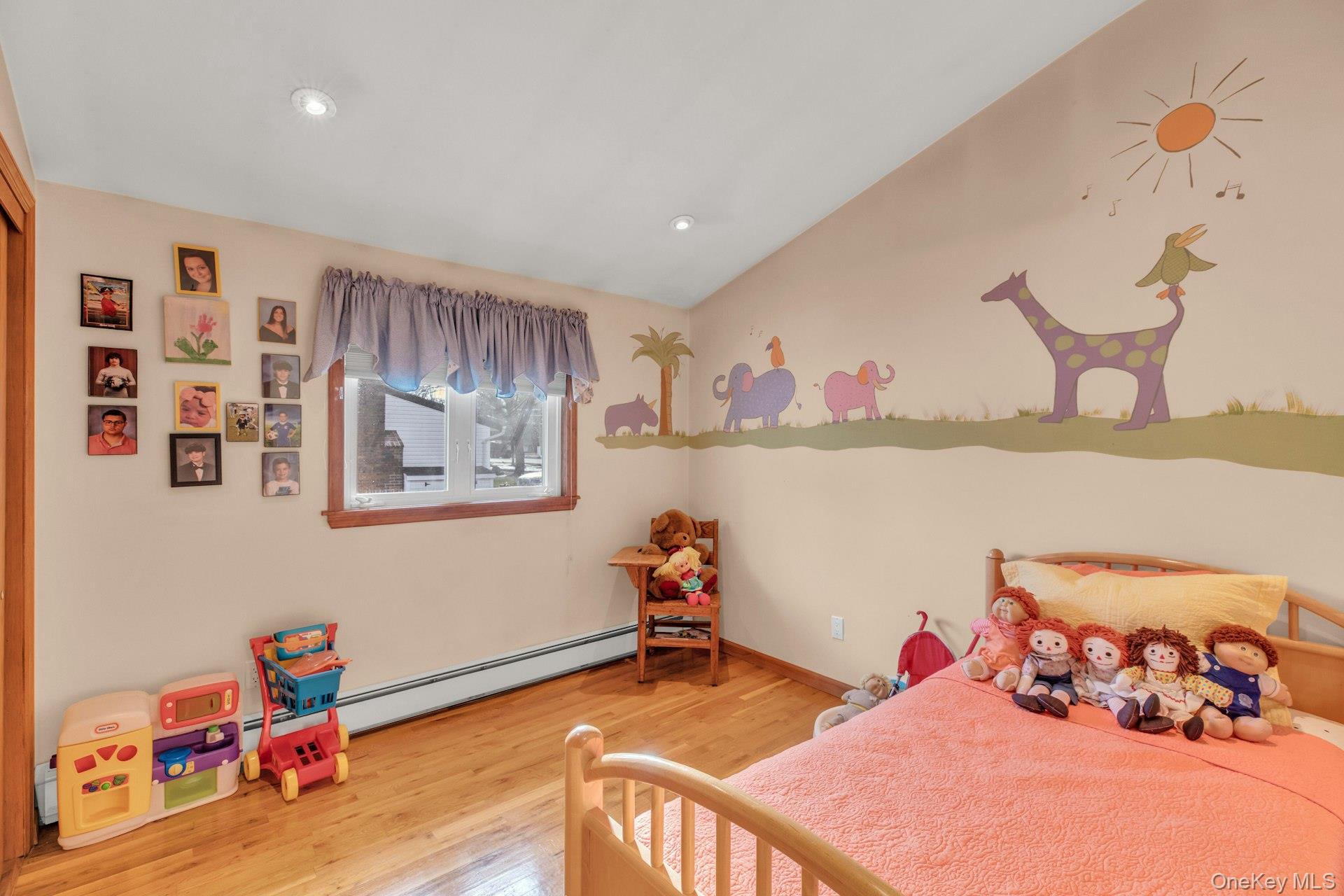 1044 Commack Road Dix Hills, NY 11746 - Photo 23 of 29 Bedroom with light wood-style floors, lofted ceiling, and baseboard heating