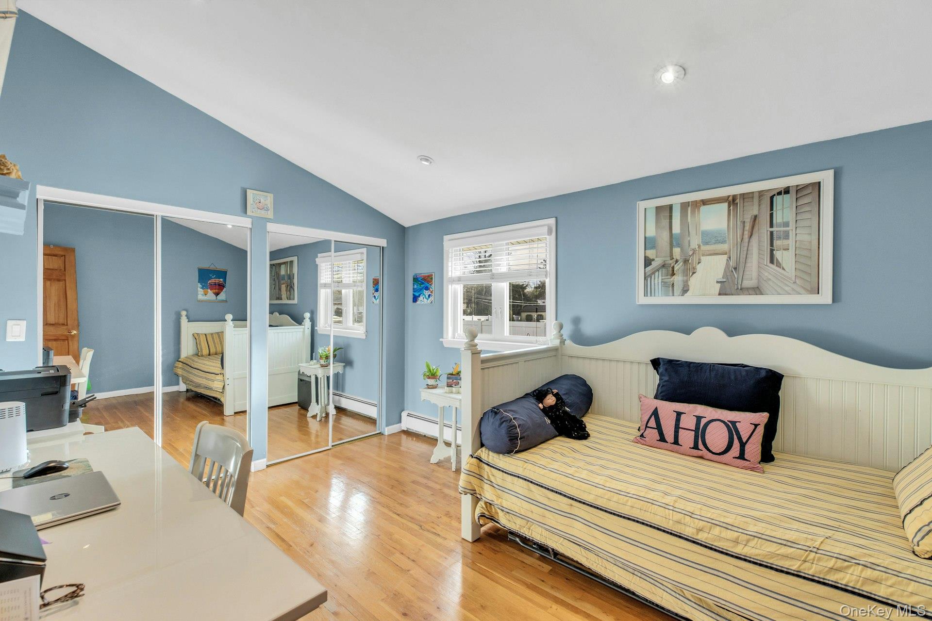1044 Commack Road Dix Hills, NY 11746 - Photo 24 of 29 Bedroom with a closet, a desk, light wood-type flooring, lofted ceiling, and a baseboard heating unit