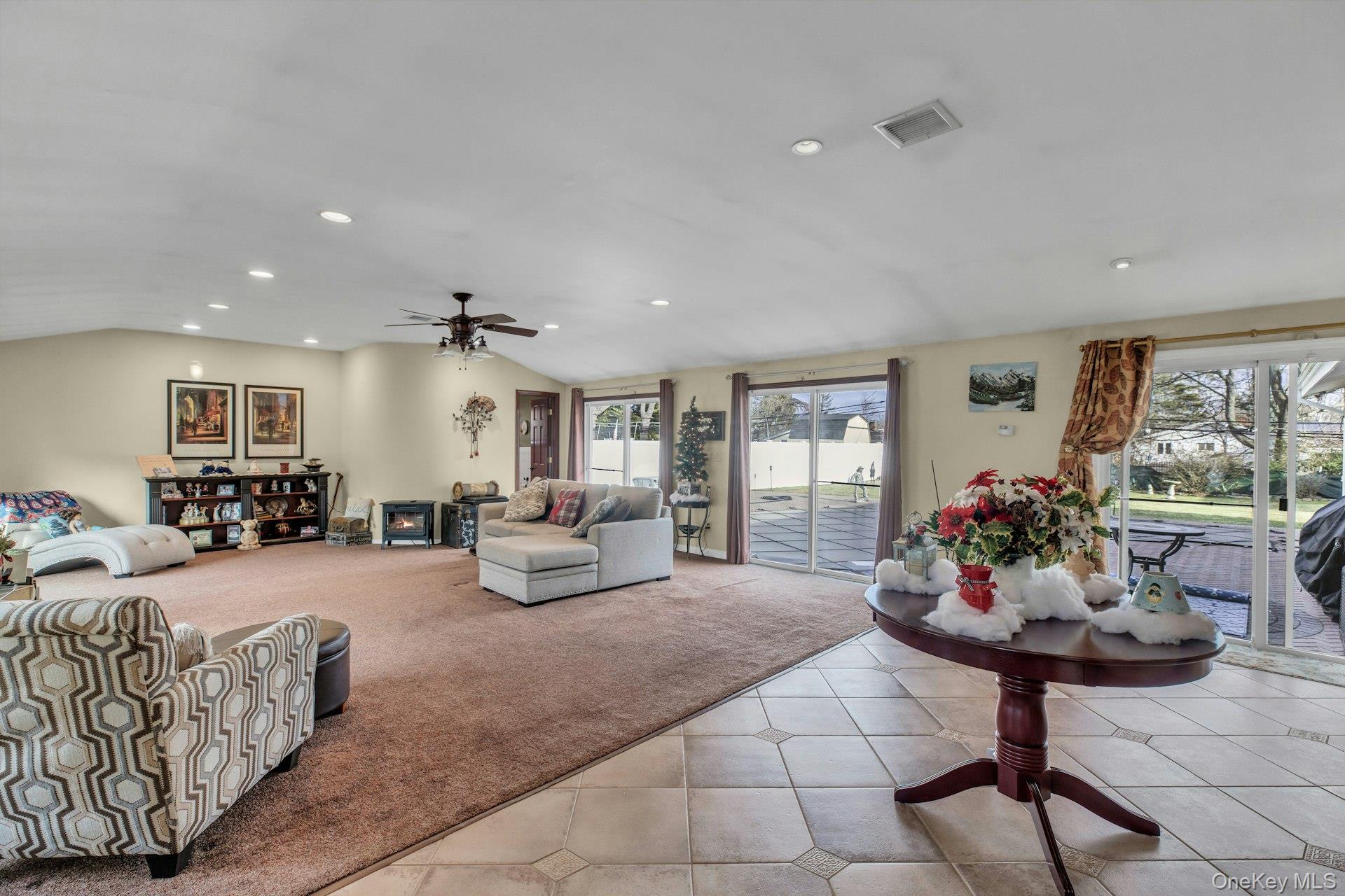 1044 Commack Road Dix Hills, NY 11746 - Photo 5 of 29 Living room featuring recessed lighting, lofted ceiling, carpet flooring, tile patterned flooring, and a ceiling fan