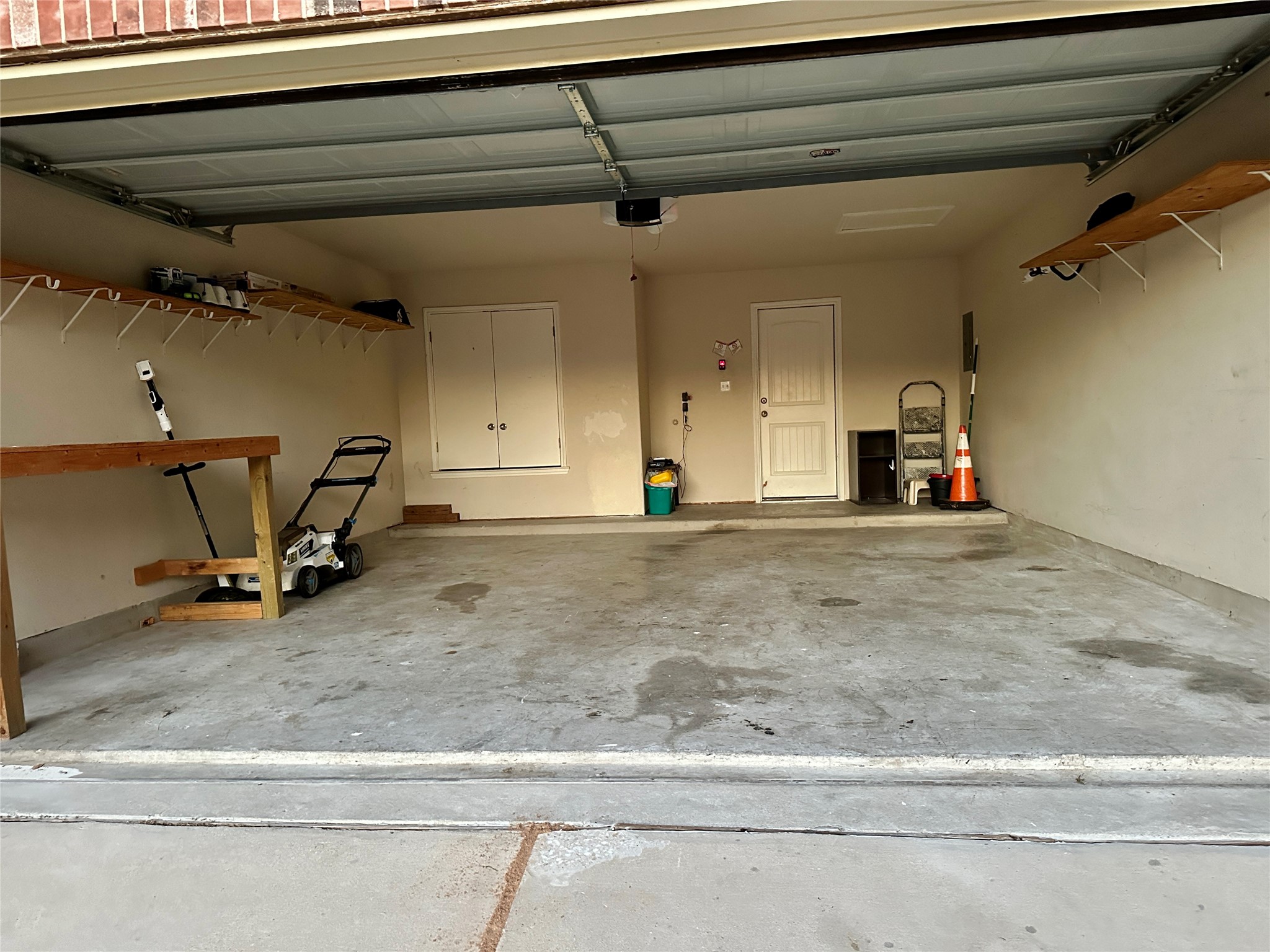 207 Dragon Ridge Road Buda, TX 78610 - Photo 28 of 38 2 Car Garage, 2 Remotes provided, electric mower & weed wacker with batteries provided
