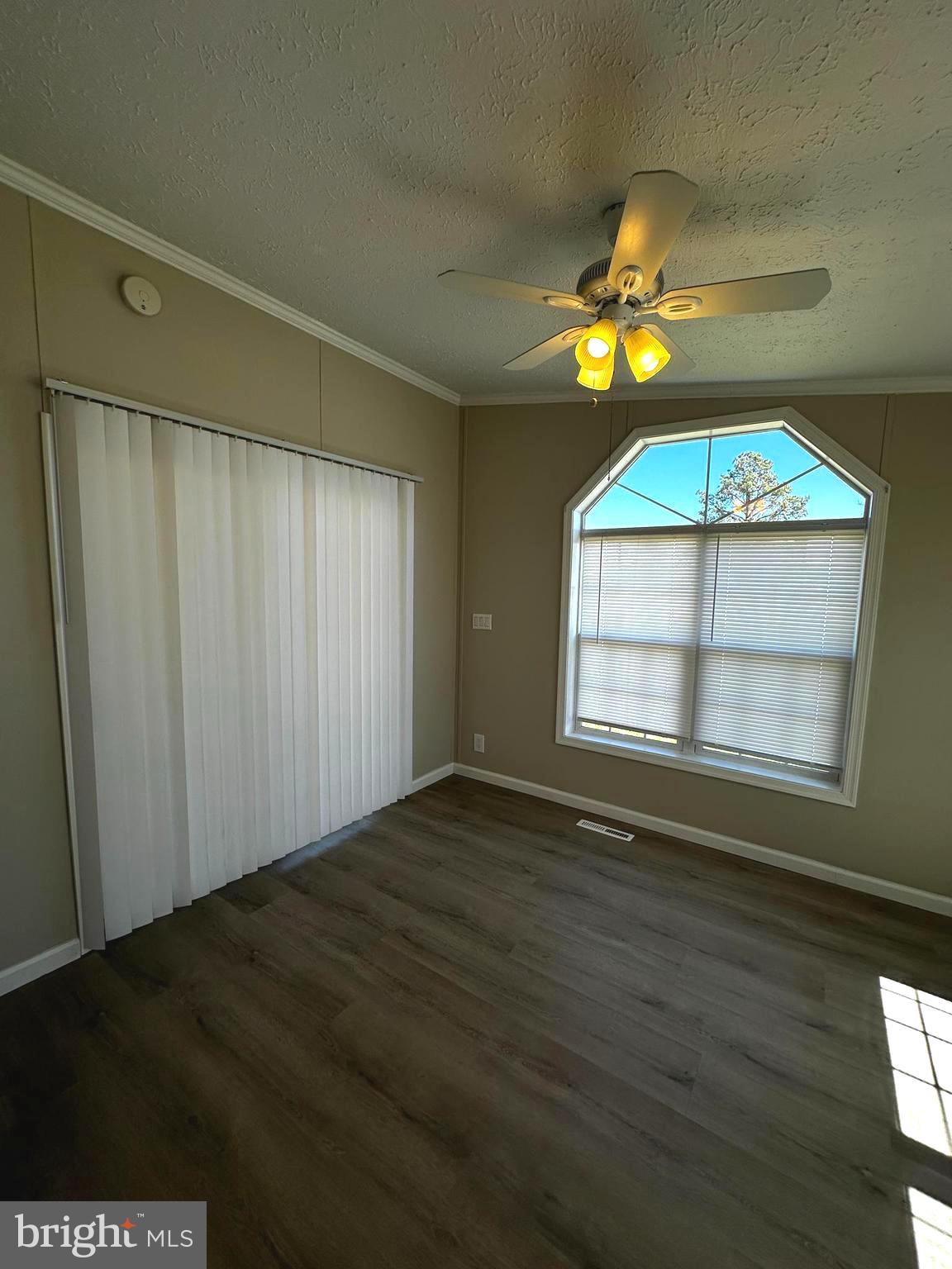 11433 Trussum Pond Road Laurel, DE 19956 - Photo 16 of 27 a view of an empty room with a window and wooden floor