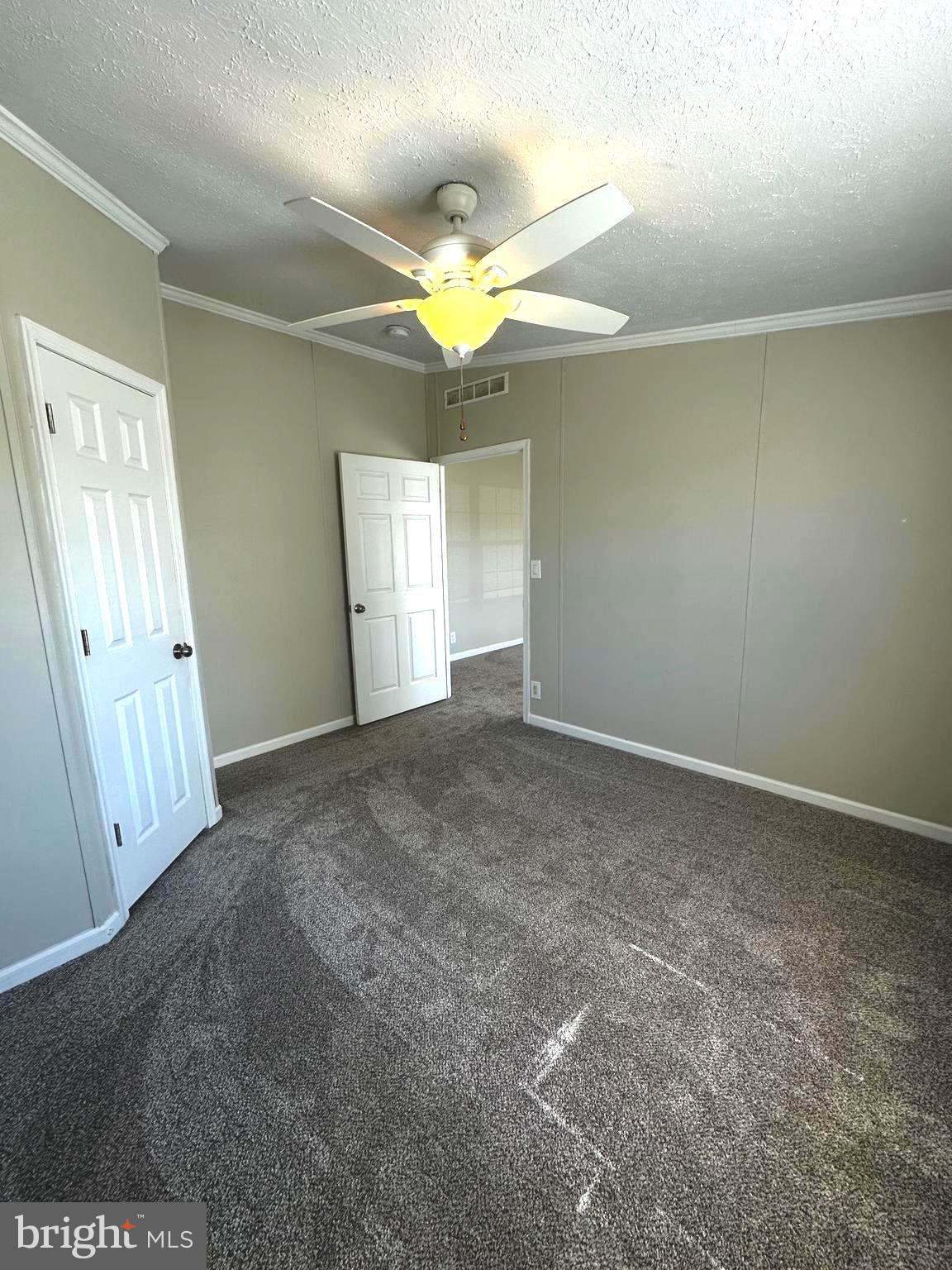 11433 Trussum Pond Road Laurel, DE 19956 - Photo 23 of 27 an empty room with windows and fan