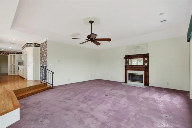 a view of an empty room with a fireplace and a large window