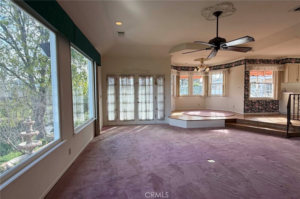 3985 Rice Road Riverside, CA 92506 - Photo 20 of 45 View from side of fireplace in the step-down family room with view of outdoor fountain, and steps leading to the kitchen.