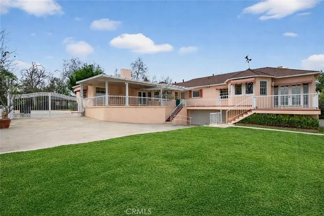 a view of a house with a yard and a garden