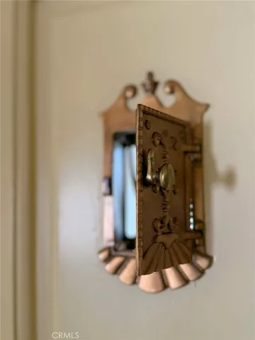 a view of a hallway with wooden floor and a bathroom