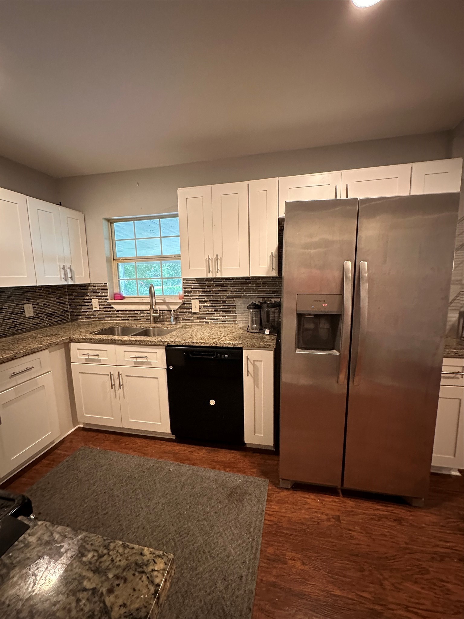 4802 Eppes Street Houston, TX 77021 - Photo 16 of 34 a kitchen with granite countertop a refrigerator and a stove top oven