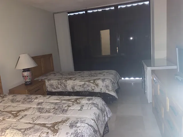 a bedroom with a bed and a mirror