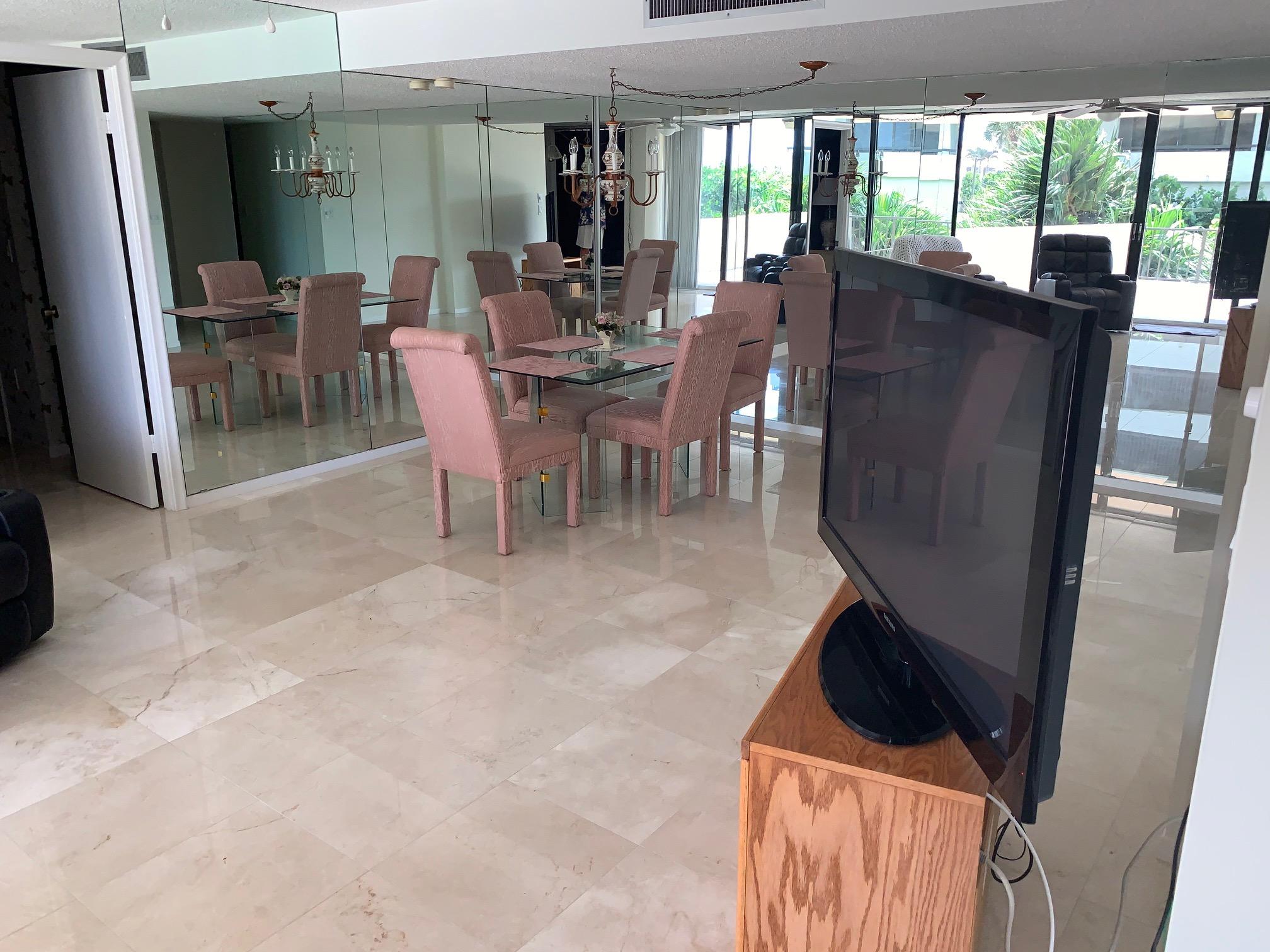 4200 North Ocean Drive, Unit 103 Riviera Beach, FL 33404 - Photo 2 of 16 a dining room with furniture and a floor to ceiling window