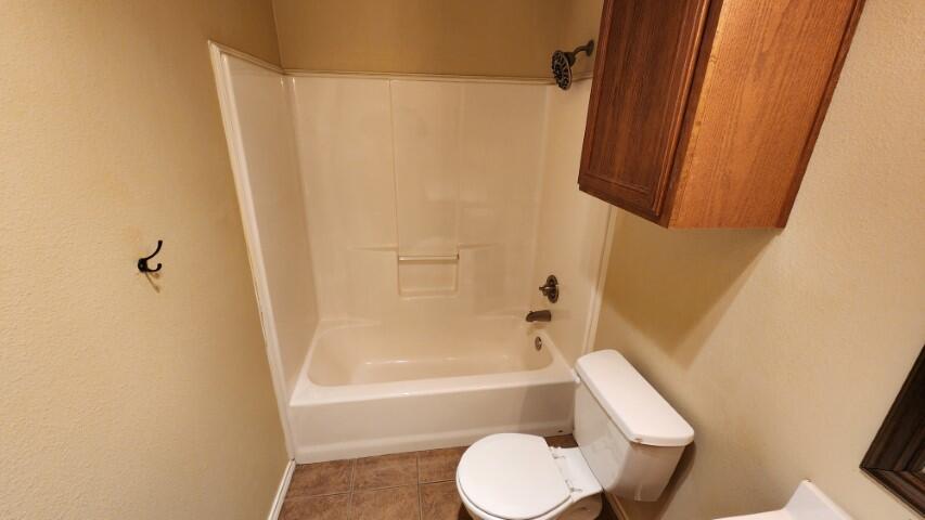 6535 93rd Street Lubbock, TX 79424 - Photo 13 of 13 a bathroom with a shower and a toilet