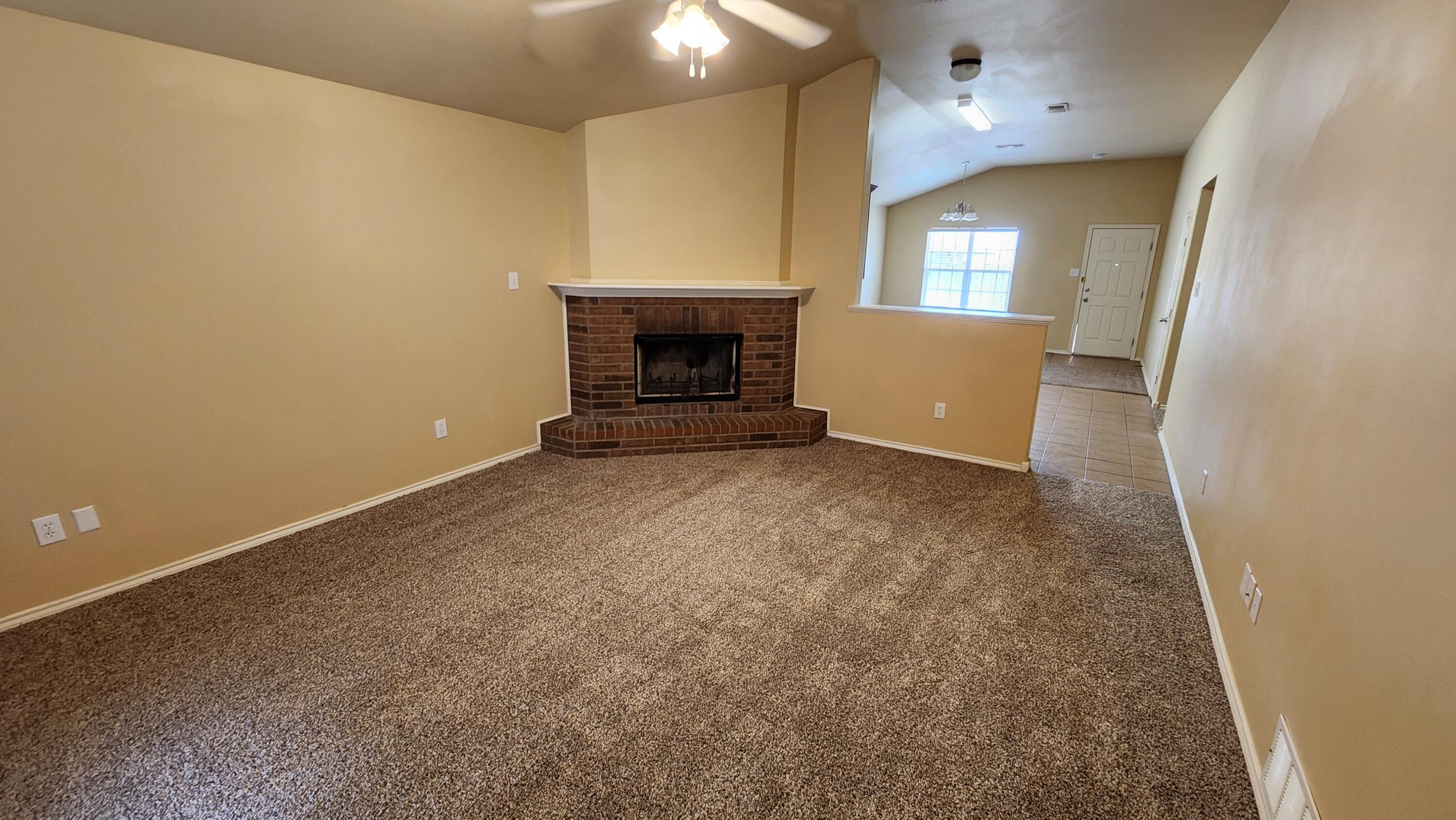 6535 93rd Street Lubbock, TX 79424 - Photo 2 of 13 an empty room with windows